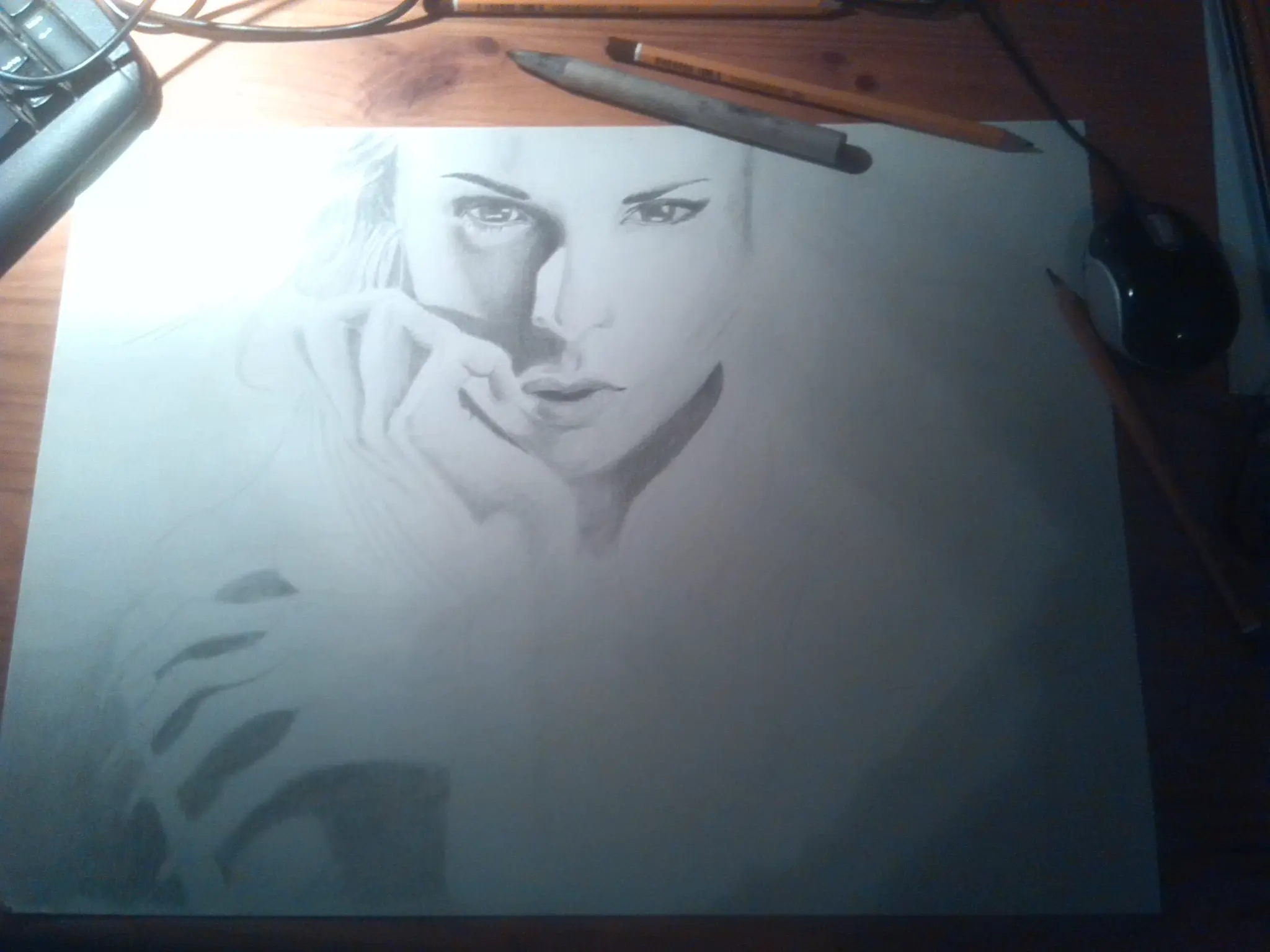 Retrato a grafito de una mujer con la mano en el rostro en gesto pensativo, con sombreado suave y realista.